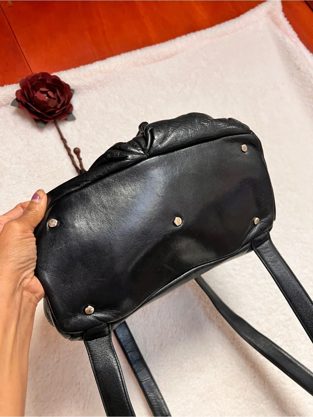 Perlina Black Leather Drawstring Flap Backpack
